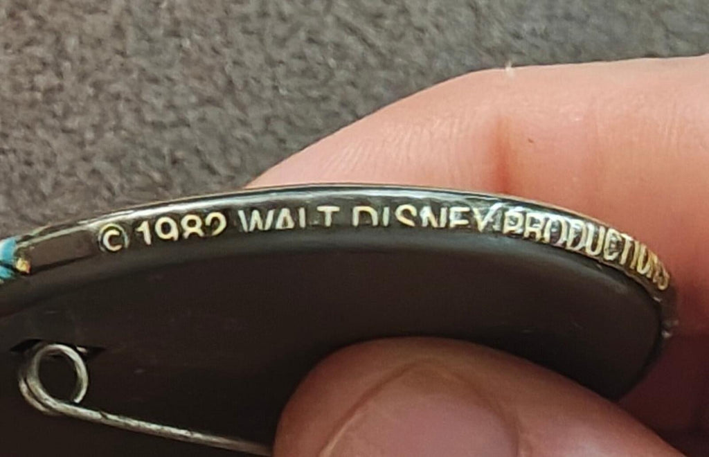 Round pinback back with '©1982 Walt Disney' border text in silver-tone metal