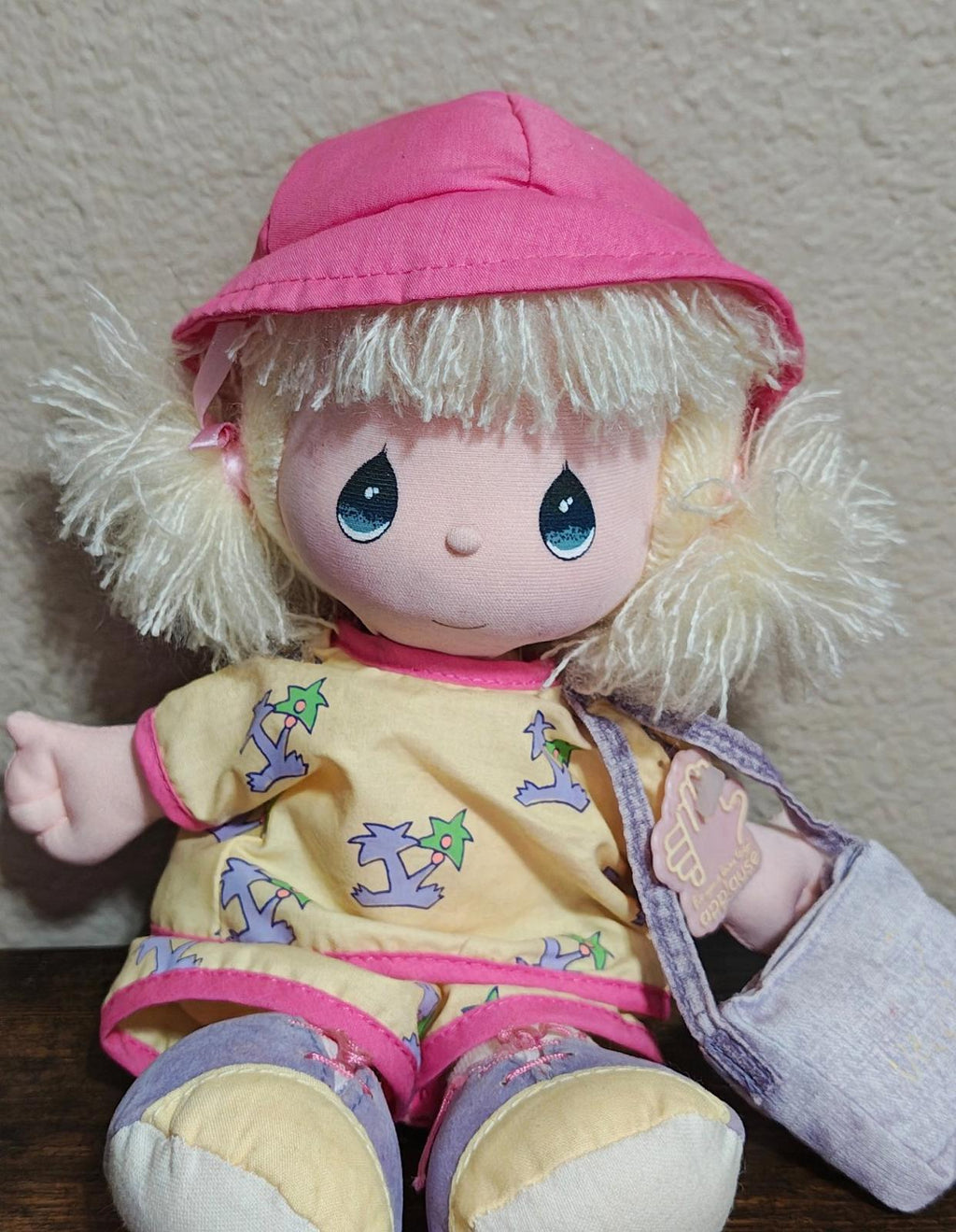 Pink plush doll seated pose with bucket hat, blonde hair, denim overalls and smiling face