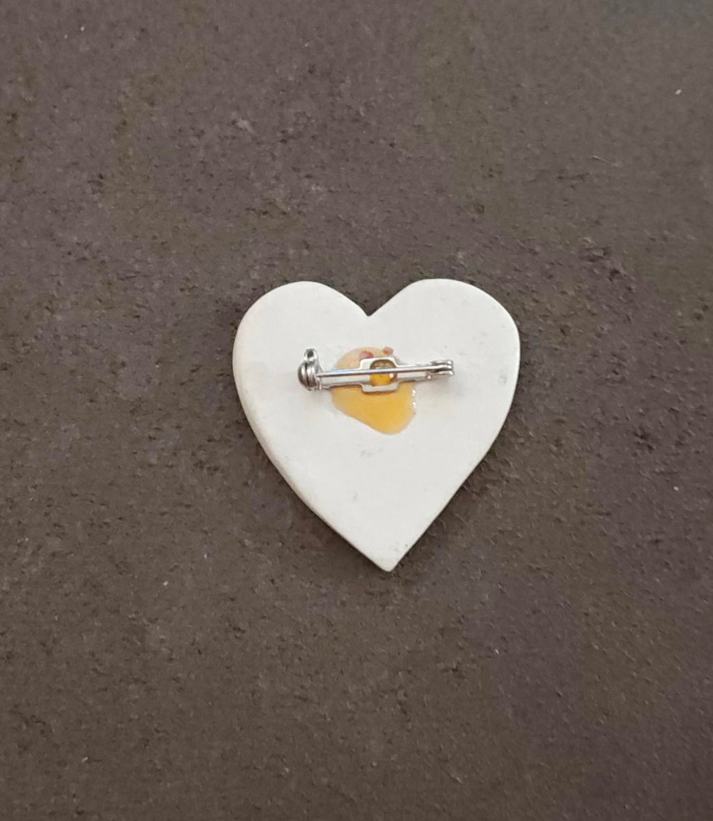 Heart-shaped ceramic brooch pin back with metal safety clasp on pin stem
