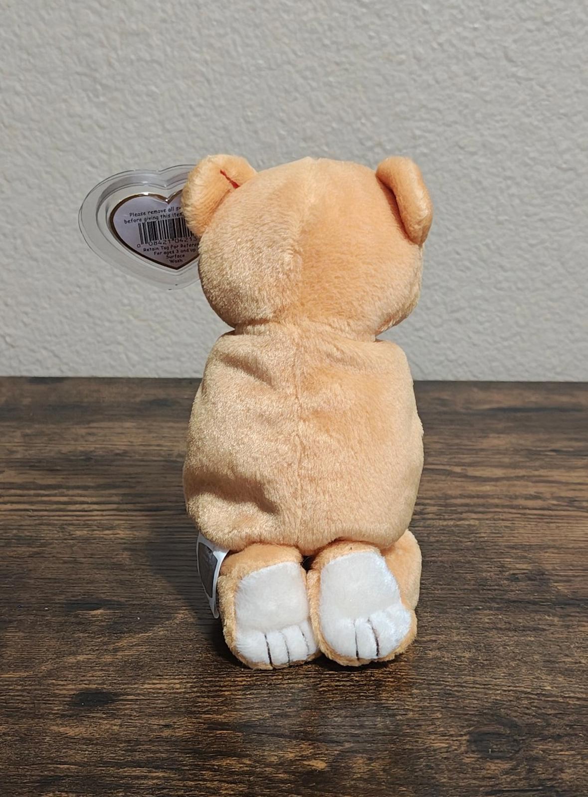 Brown plush bear back view with white feet and clear heart Ty tag