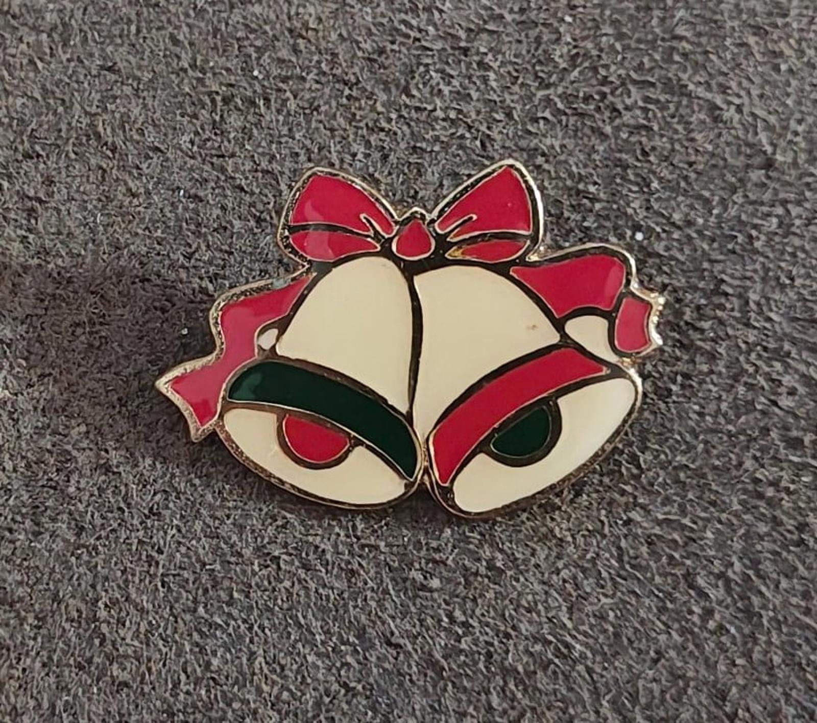 Gold tone enamel Christmas bells brooch with red ribbon bows and dark green enamel highlights