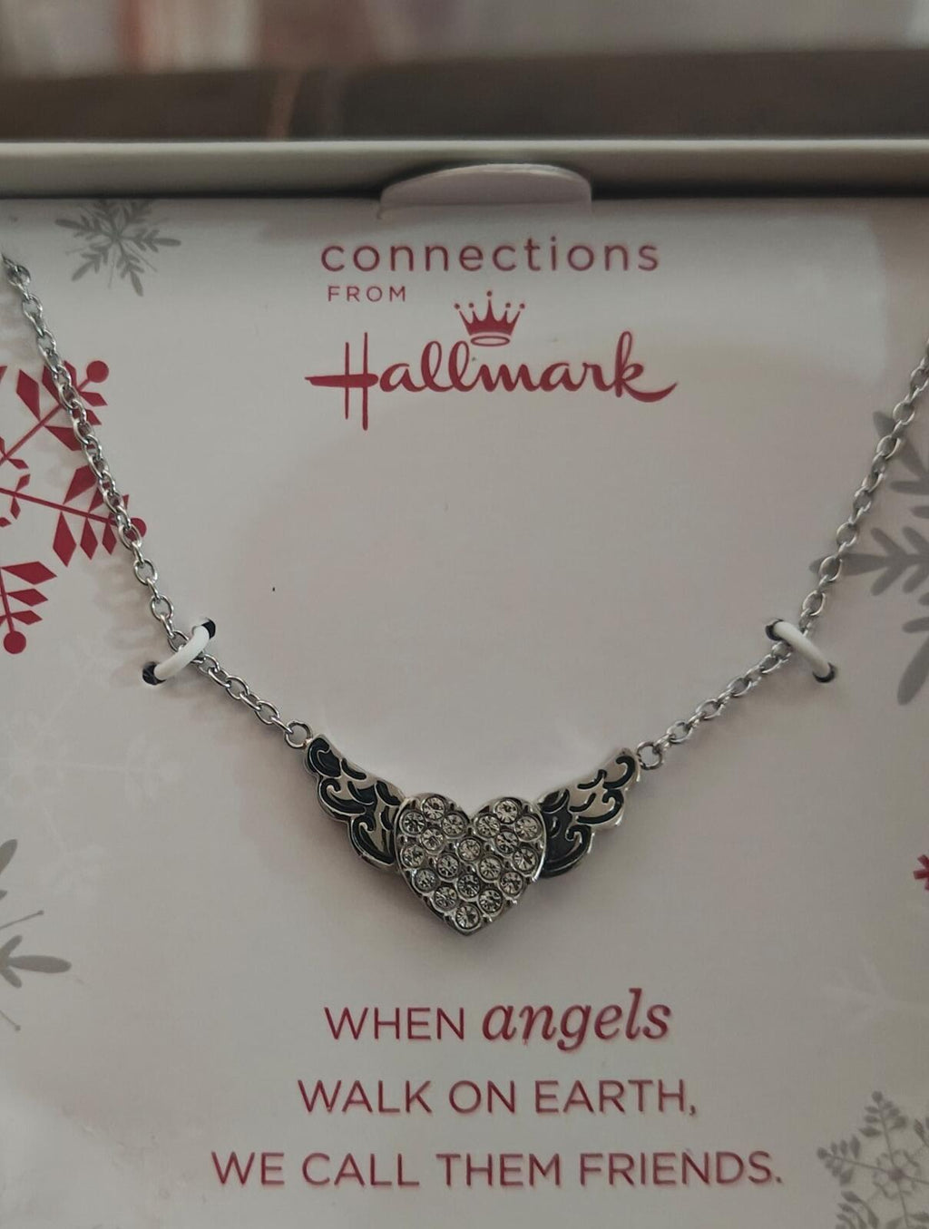 Silver-tone heart-and-angel-wings charm necklace with detailed heart centerpiece