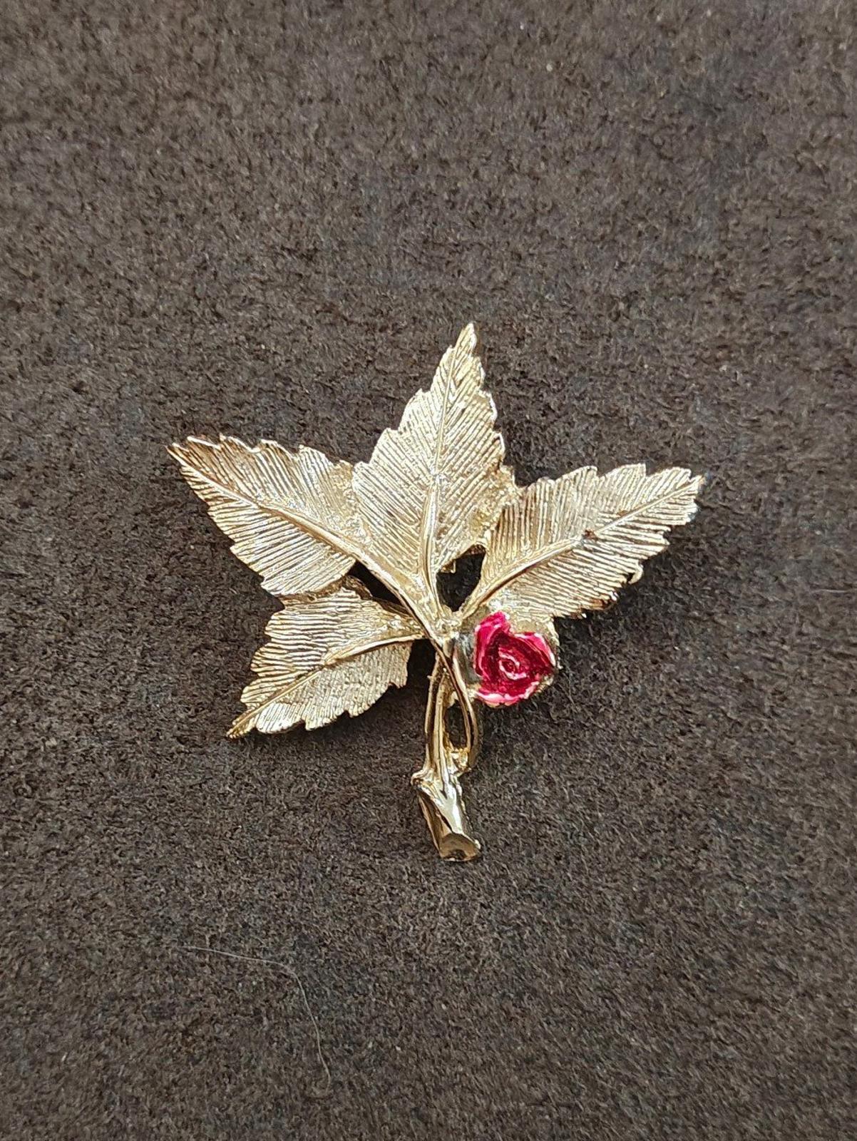 Gold-tone leaf cross pin brooch with red rose and Mary medallion detail