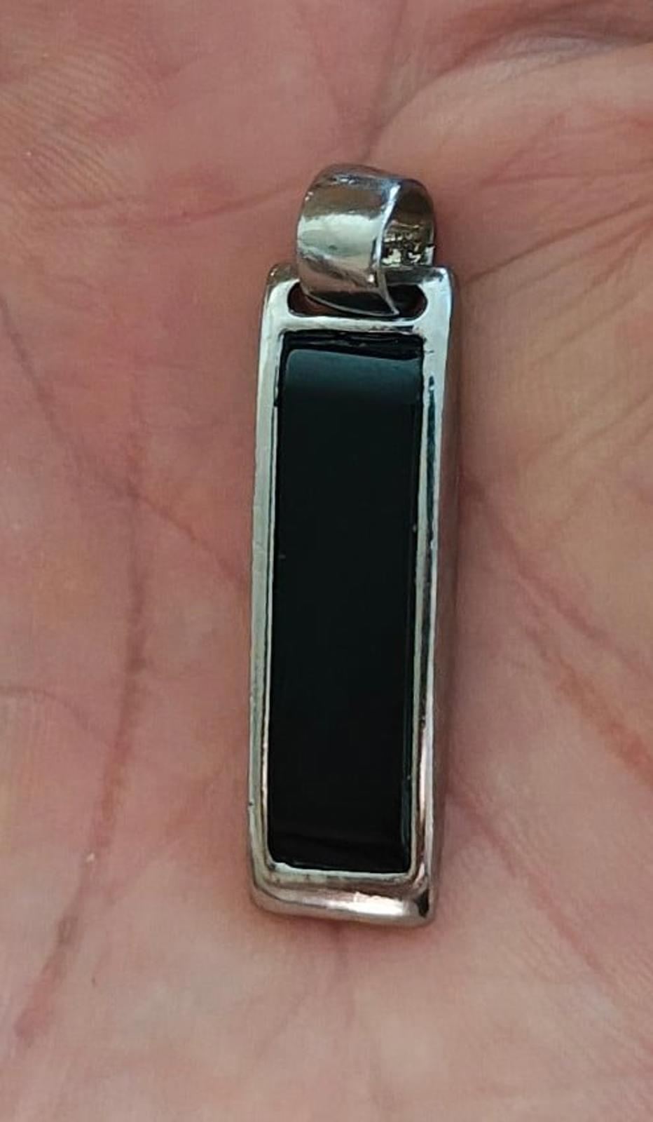 Silver-tone rectangular slide pendant with dark black inlay window on front.