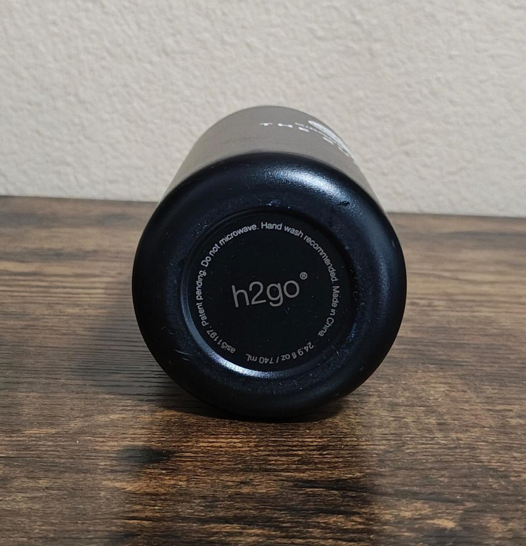 Bottom of black insulated water bottle with h2go branding and care text.
