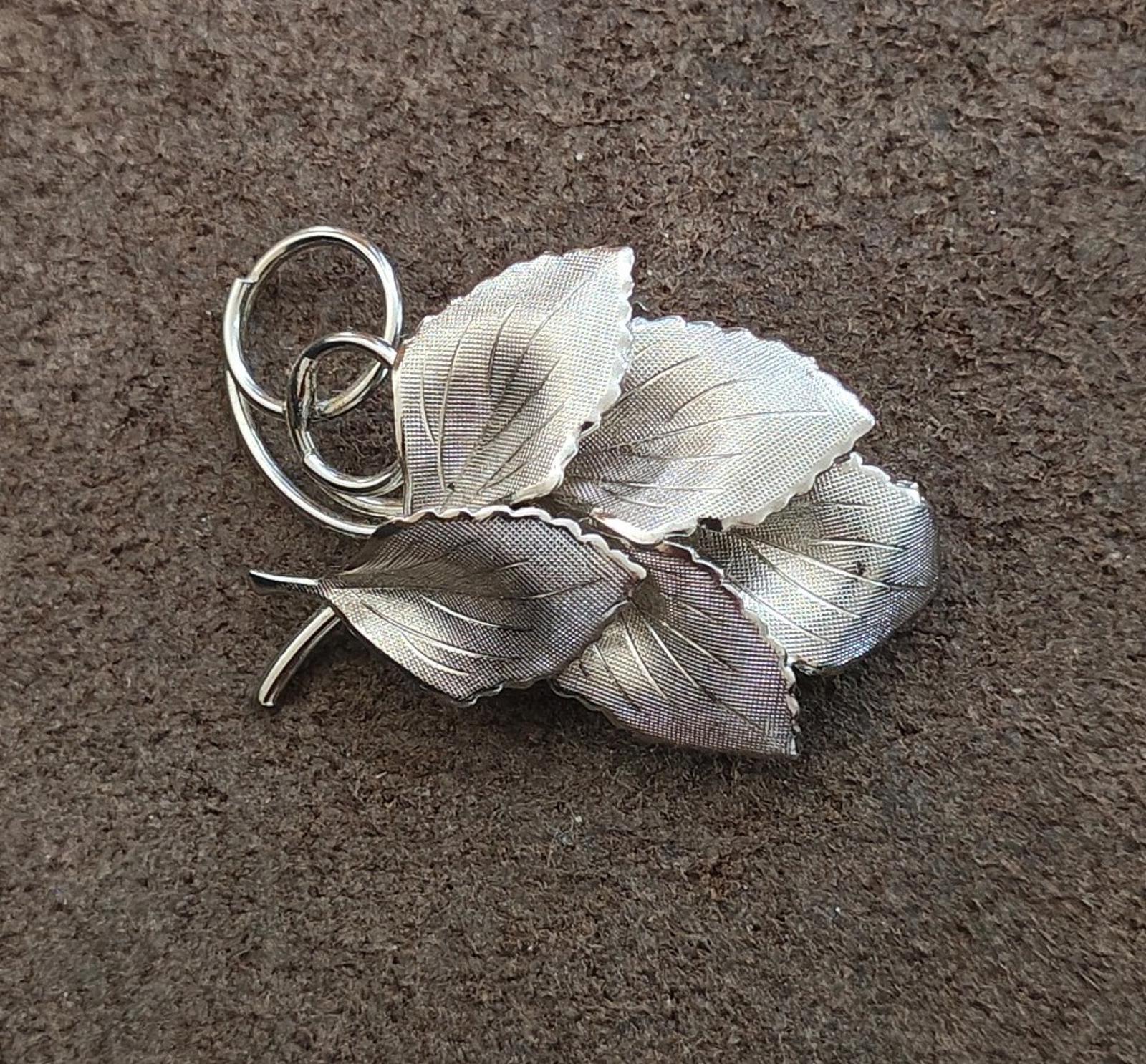 Silver leaf bunch brooch with textured veins, ring loop clasp, visible pin