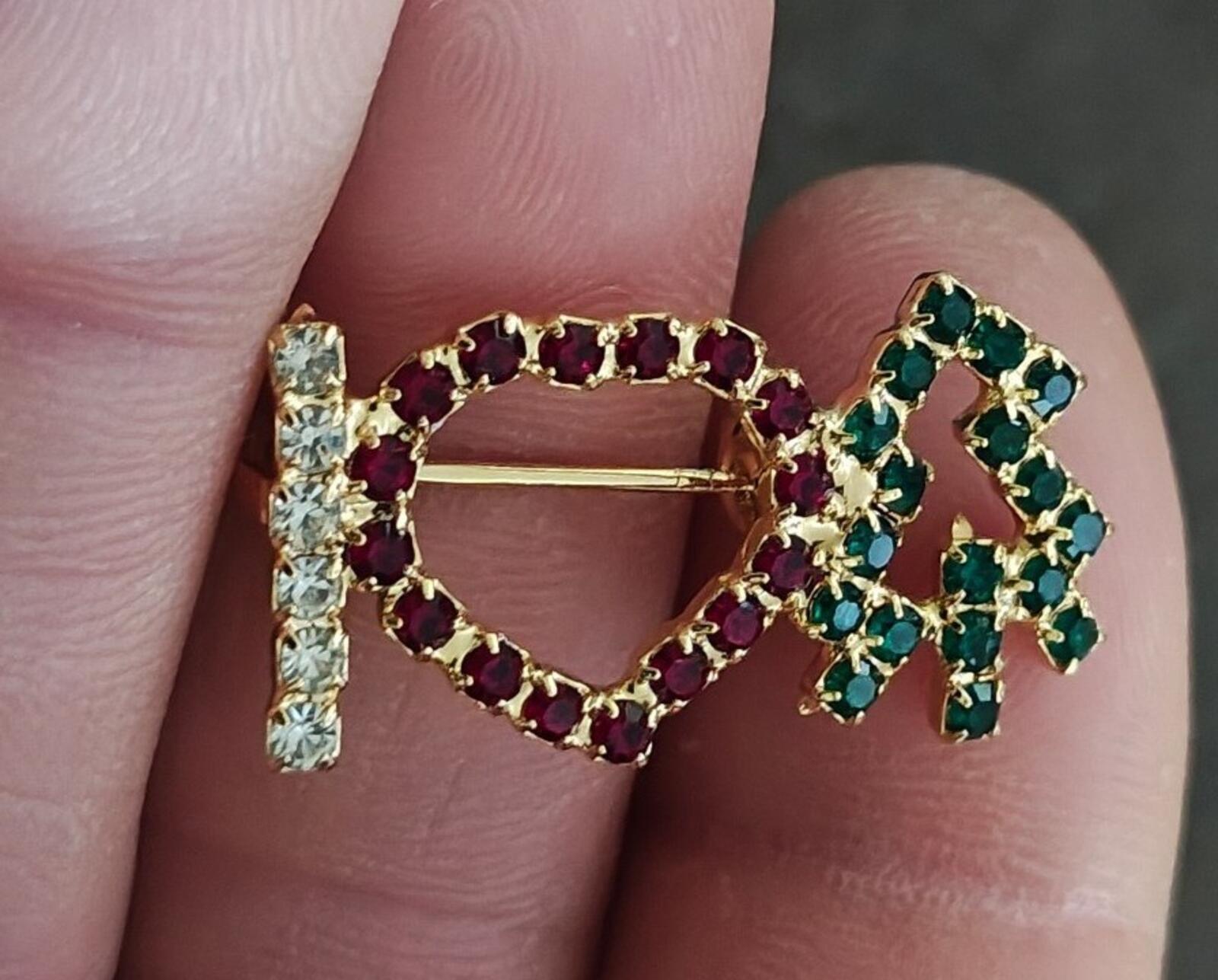 Gold-tone rhinestone brooch worn on fingers: red heart, green tree, clear stone vertical bar