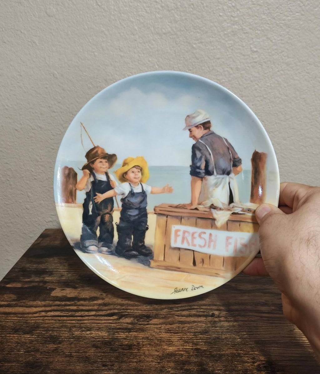 Blue ceramic decorative plate featuring an illustrated fish market crate and “Fresh Fish”