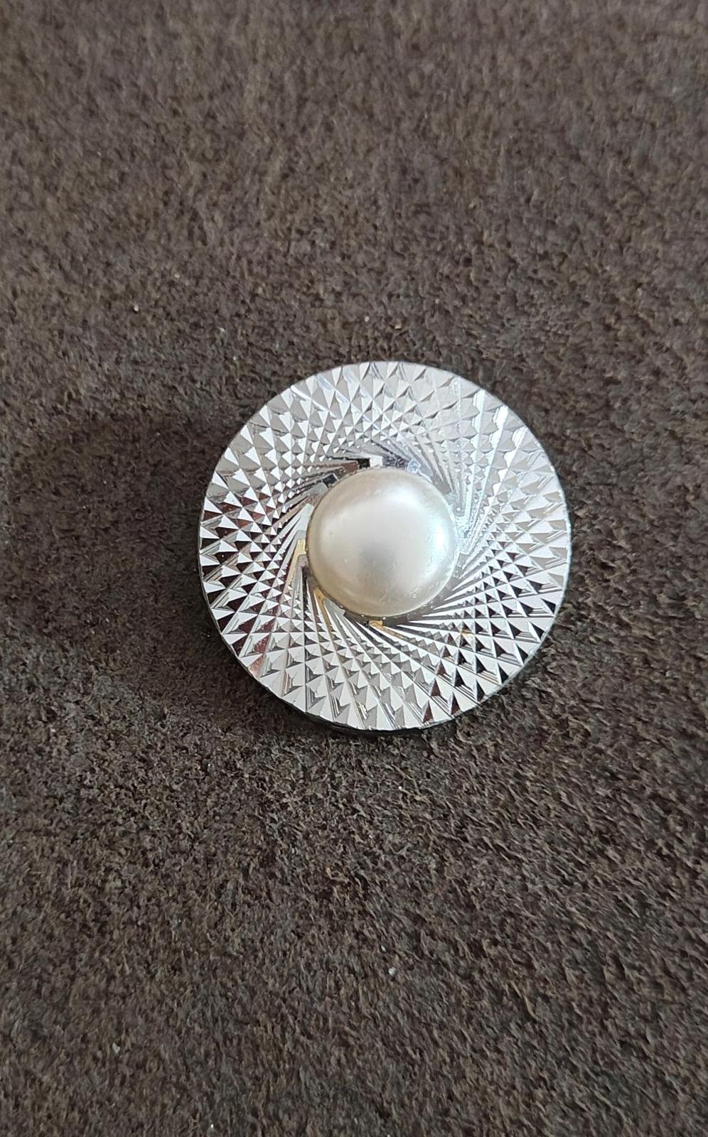 Round silver-tone scarf clip on fabric; diamond-cut border with faux pearl center