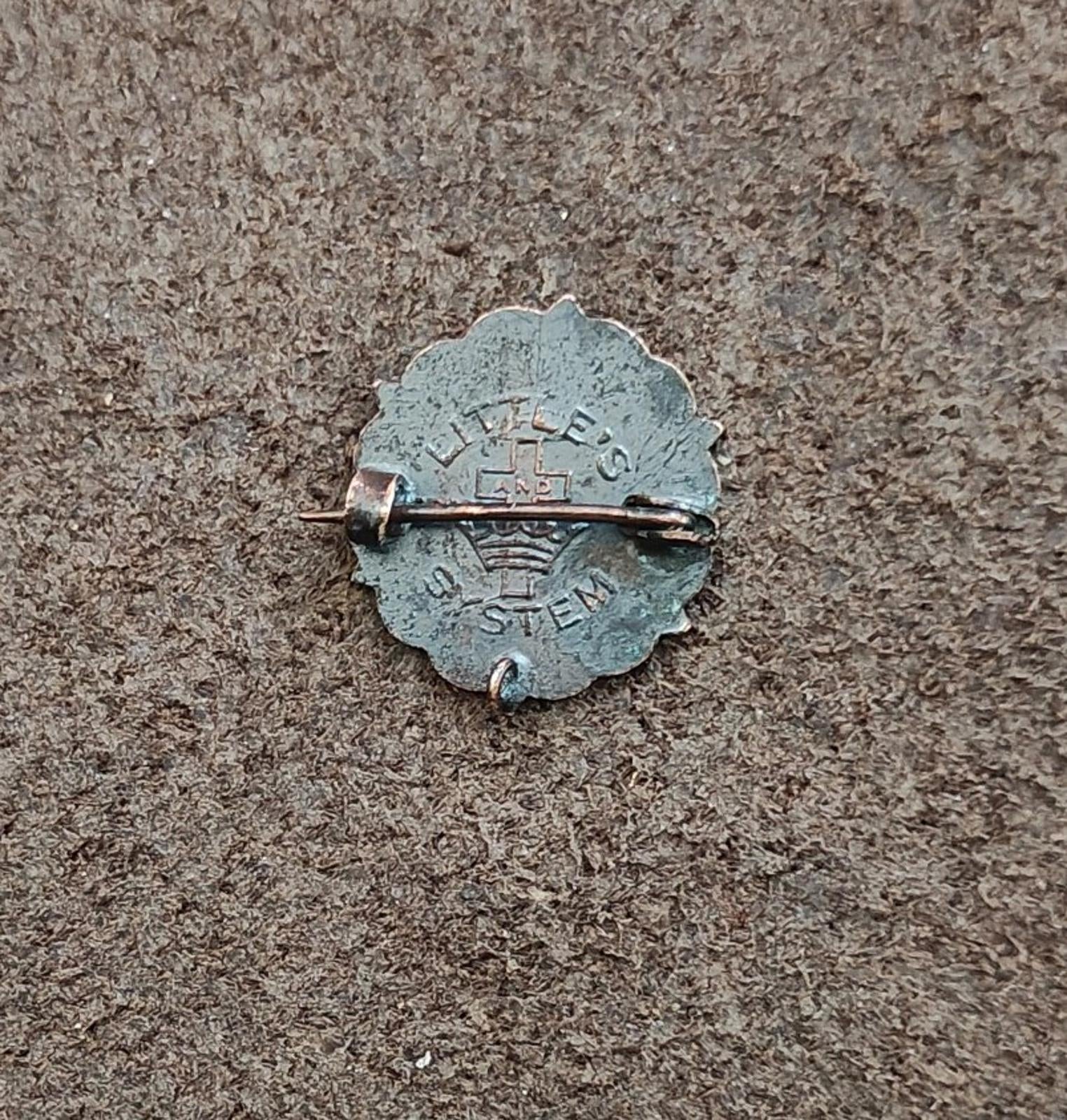 Bronze pin back with safety clasp and stamped cross logo