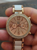 Ladies rose-gold fashion watch with rhinestone bezel, white dial, and linked bracelet