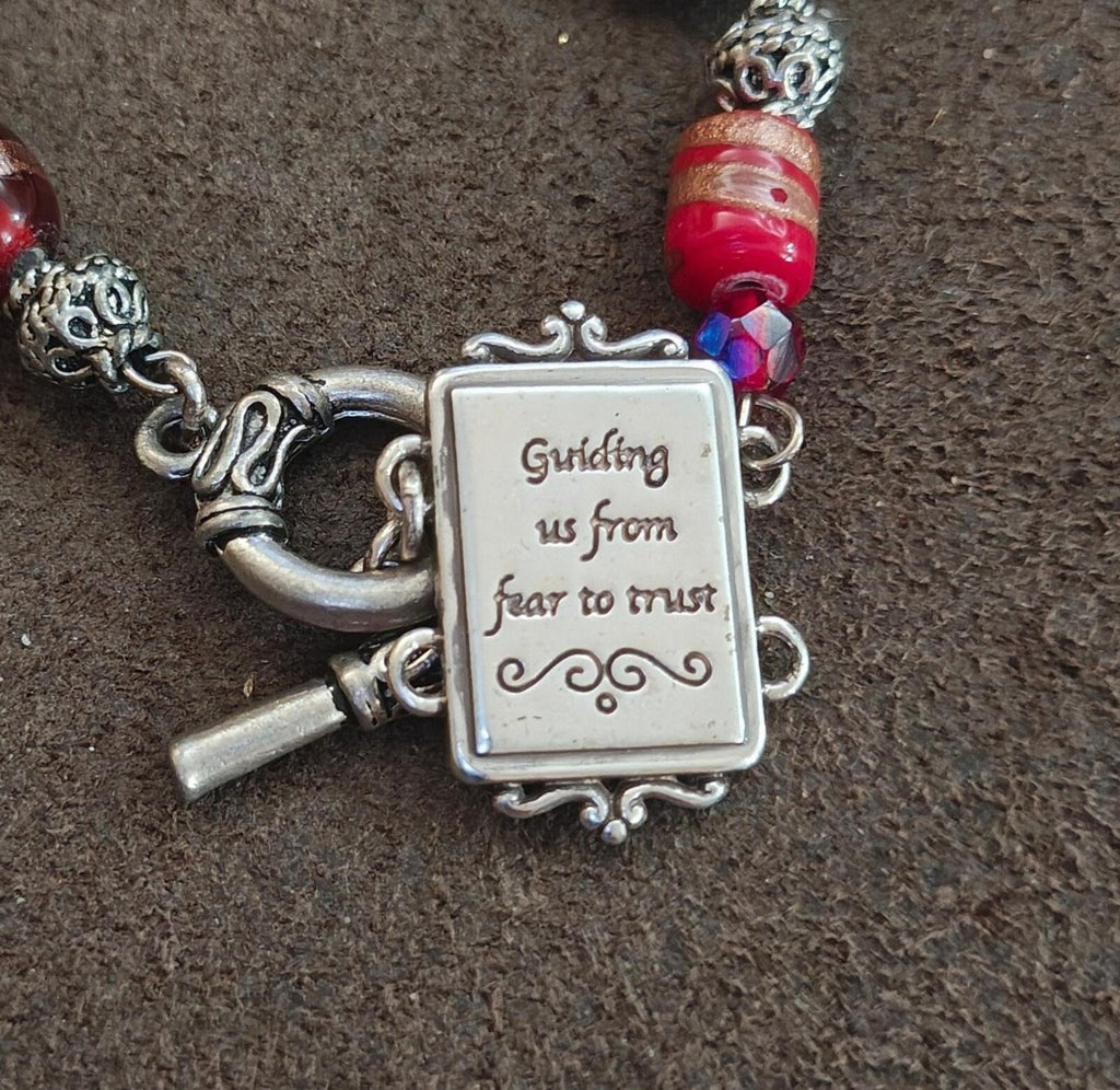 Silver message charm clasp area on portrait link bracelet with red glitter bead and blue bead