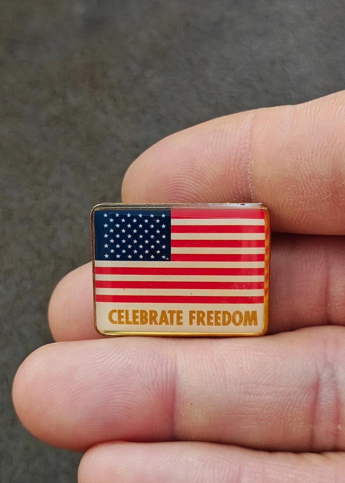 Small rectangular flag pin in gold-tone frame with “CELEBRATE FREEDOM”