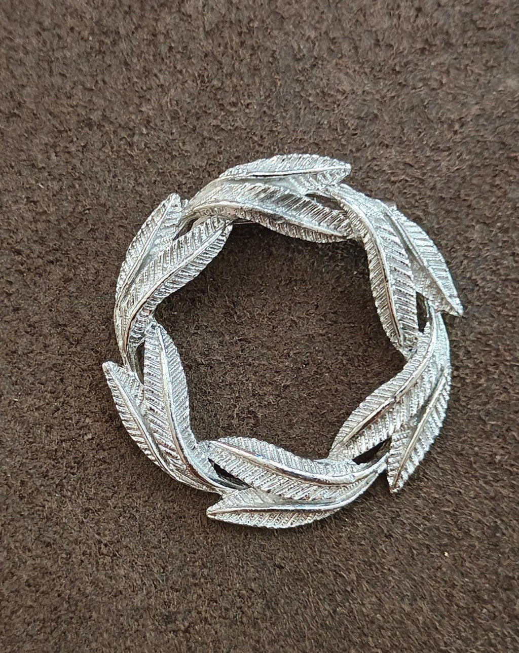 Silver-tone leaf wreath pin brooch with open center and detailed textured finish