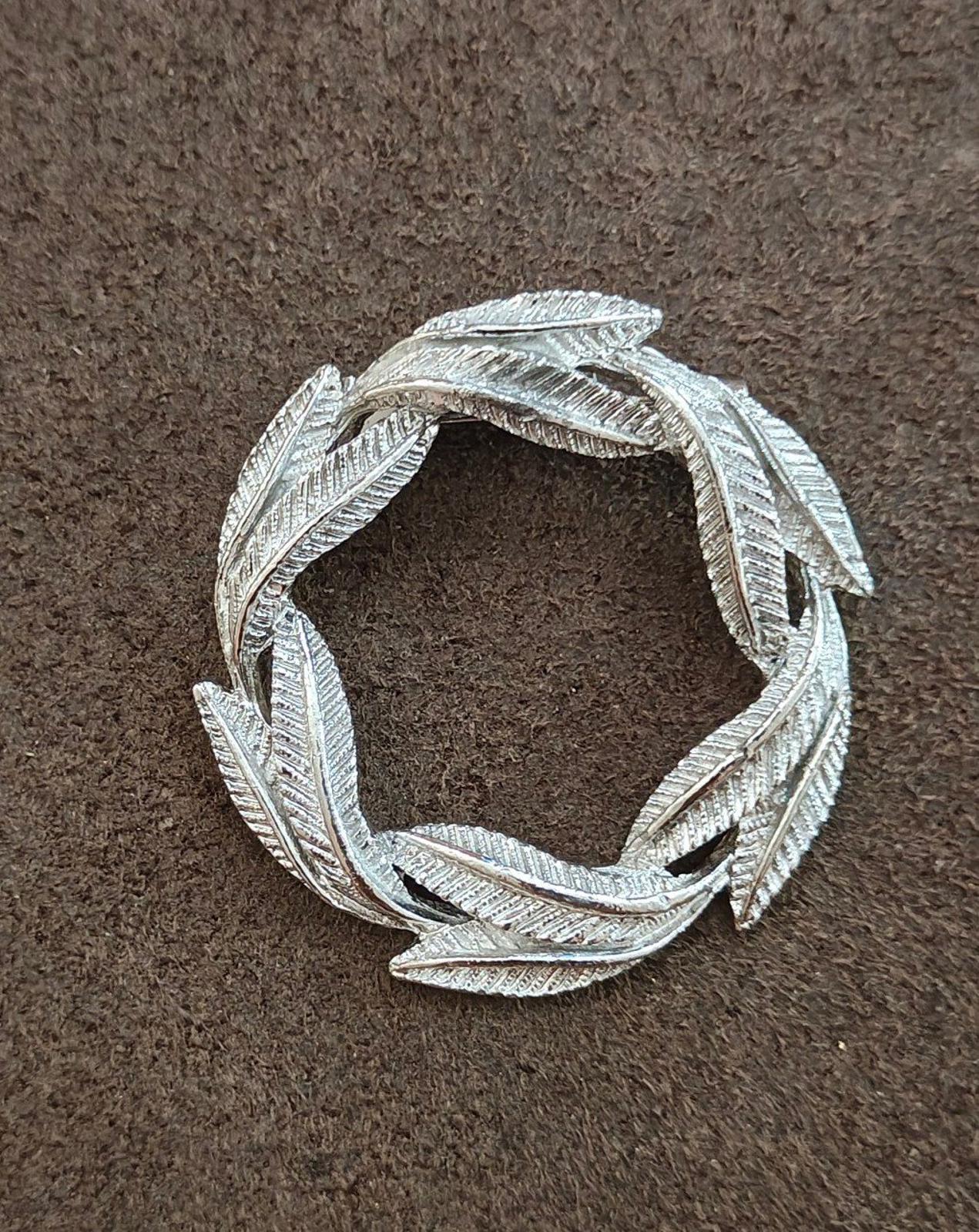 Silver-tone leaf wreath pin brooch with open center and detailed textured finish