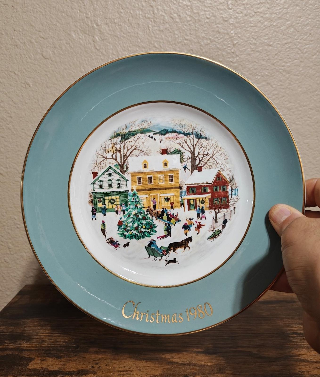 Light blue Avon Country Christmas porcelain plate with 1980 village scene and gold rim
