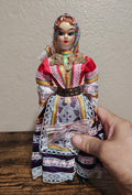 Female folk doll in red and purple embroidered gown with gold coin belt and lace sleeves