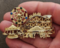 Gold tone carnival wheel and carousel brooch with colorful round stones and dangling horses