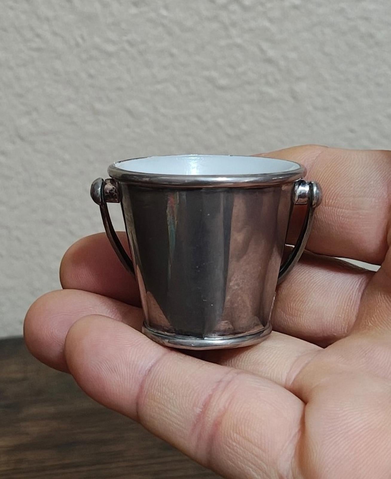 Mini silverplated bucket pail with two loop handles and white interior