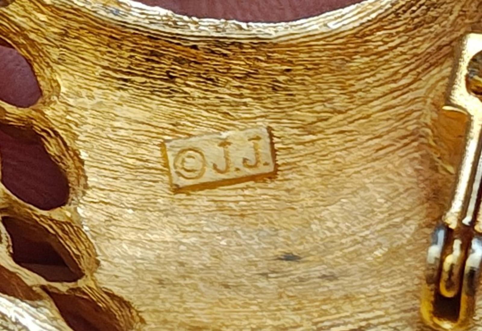 Gold tone brooch back with stamped 'J.J.' on textured metal
