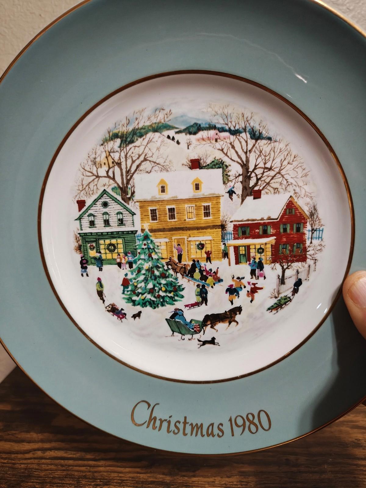 Light blue porcelain Christmas plate with 1980 scene, gold border, and gold-rim edge