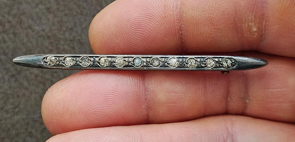 Silver bar brooch with clear rhinestone rows and scalloped metalwork ends