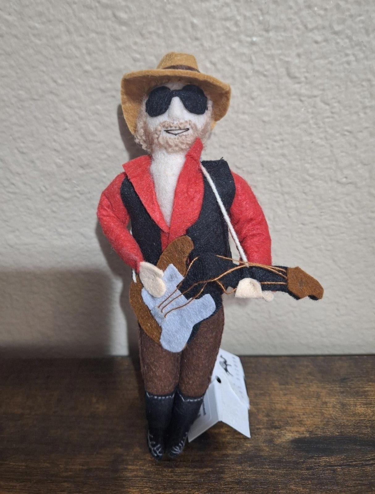 Felt and wool musician ornament with red jacket, dark vest, hat, sunglasses, and guitar