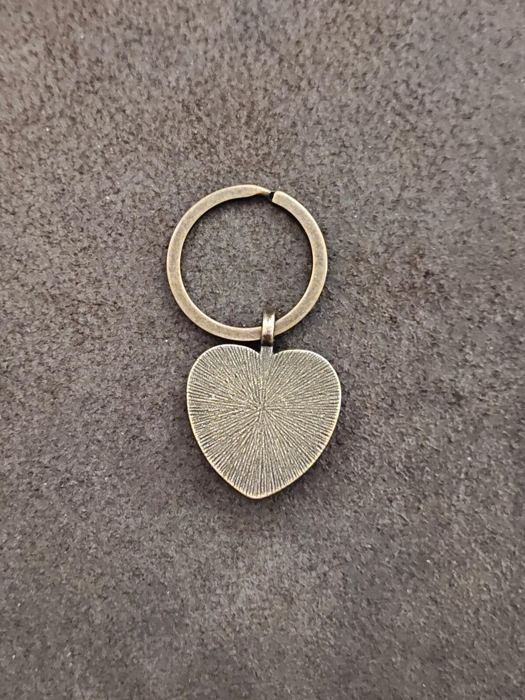 Brass-tone keychain with solid heart charm and ring, no visible pendant text
