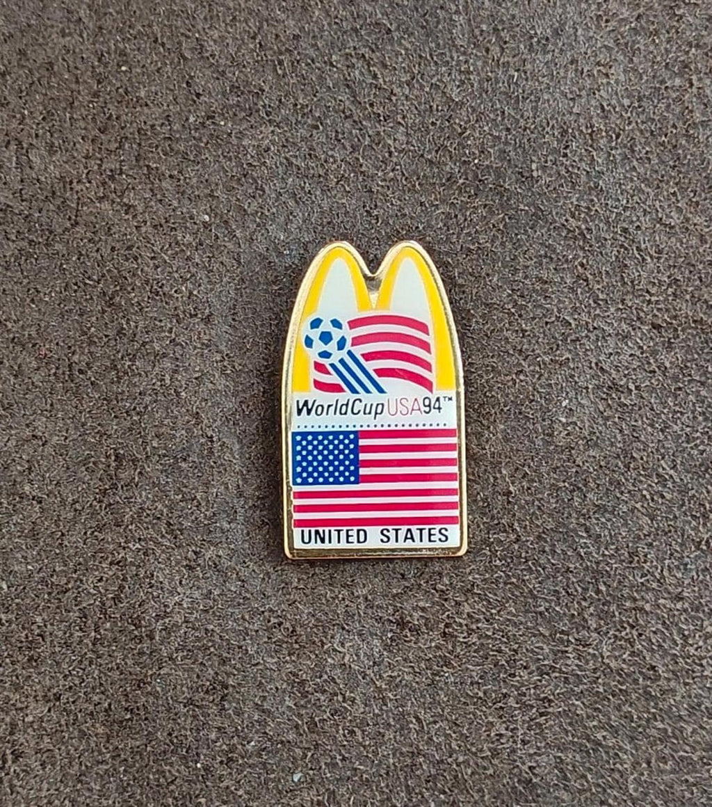 Gold-tone WorldCup USA '94 lapel pin with McDonald's arch, soccer globe, and U.S. flag