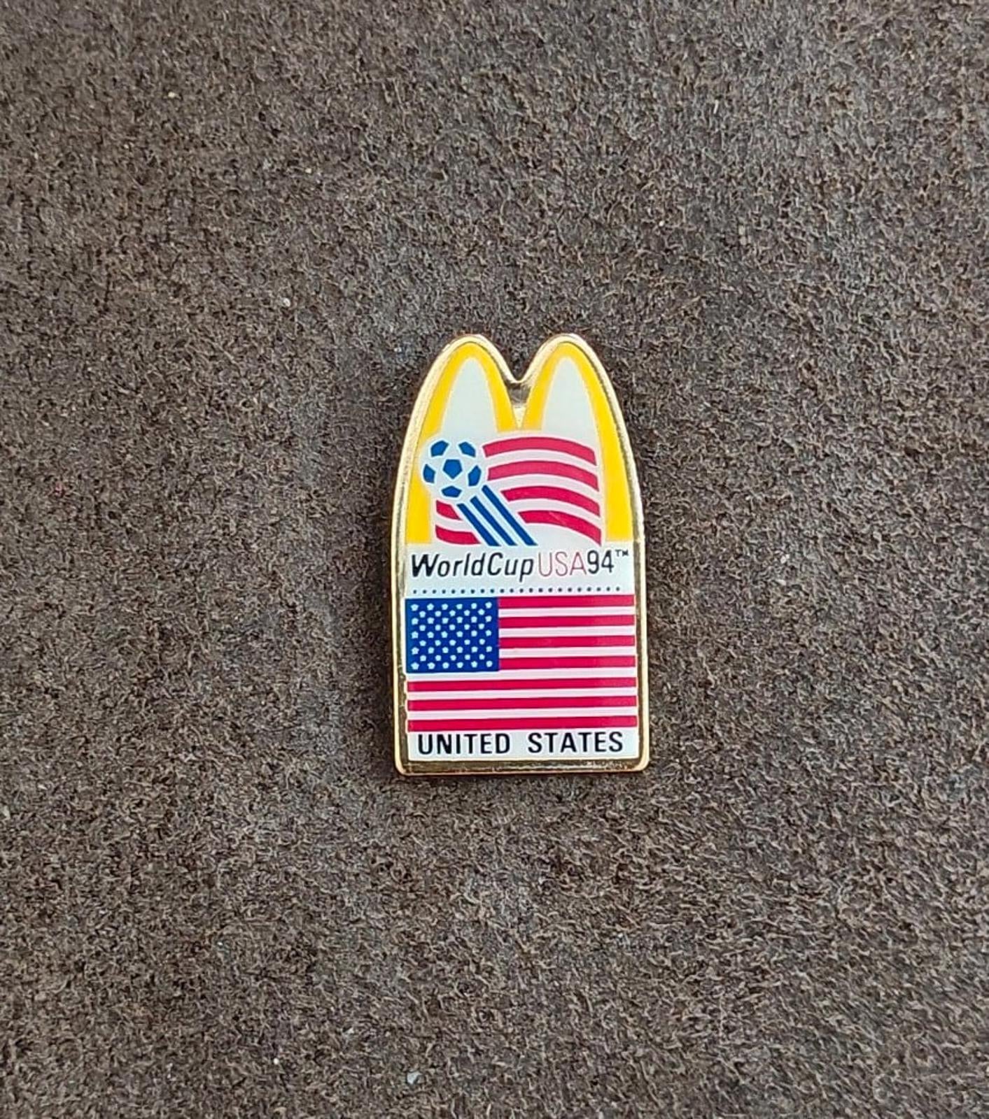 Gold-tone WorldCup USA '94 lapel pin with McDonald's arch, soccer globe, and U.S. flag