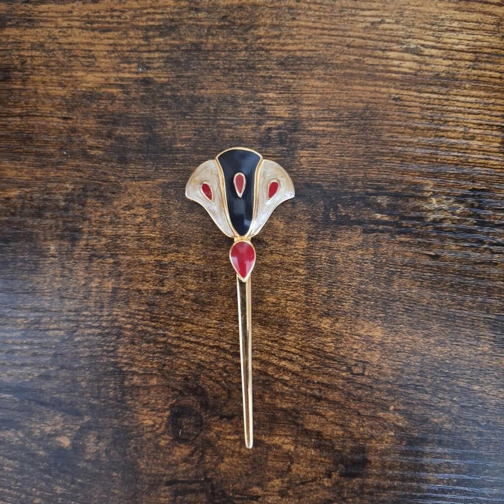 Gold enamel flower pin brooch with dark blue center and red teardrop petal details