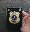 Black faux-leather toy badge holder with gold police officer emblem and silver chain