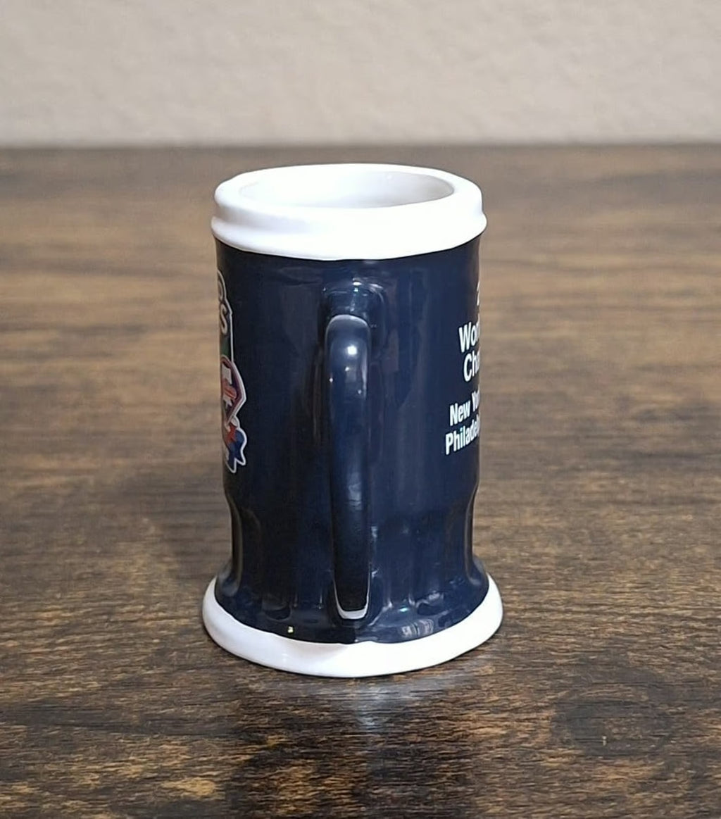 Dark blue miniature mug with handle, back side with small printed text
