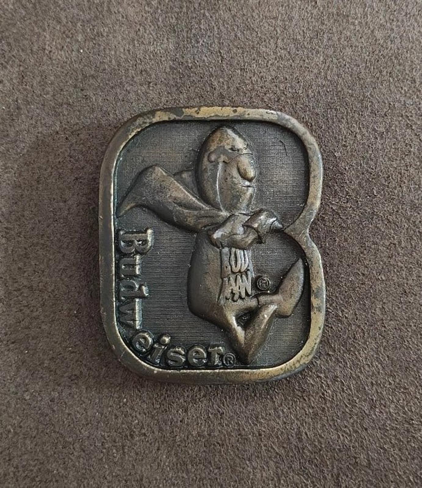 Vintage brass belt buckle, dark front with standing character and Budweiser lettering.