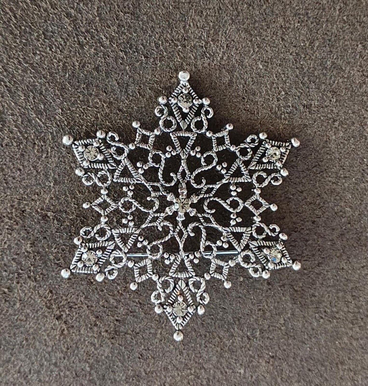 1990s Silver Tone Filigree Snowflake With Clear Rhinestone Accents Brooch.