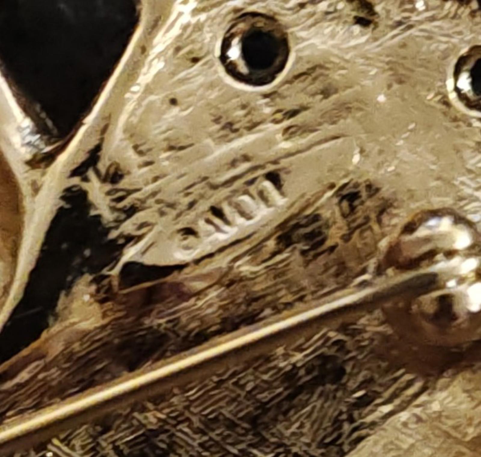 Gold-tone close-up of textured metal base on Santa sleigh brooch