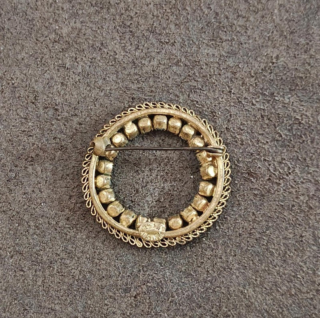 Gold-tone round brooch back with raised bead details and central bar