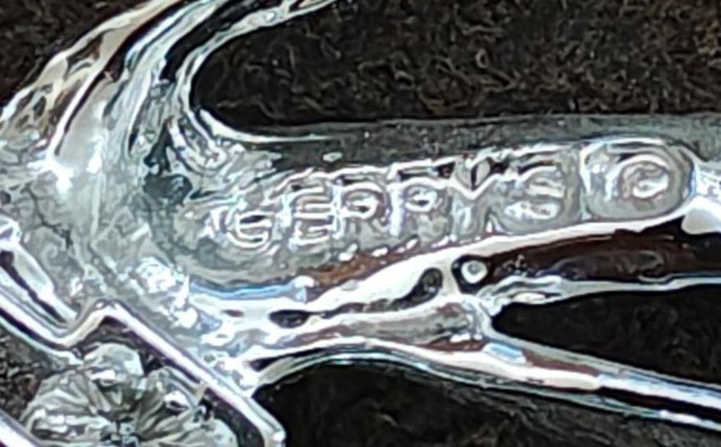 Engraved silver-toned brooch back marked "GERRY'S" with pin clasp bar close-up