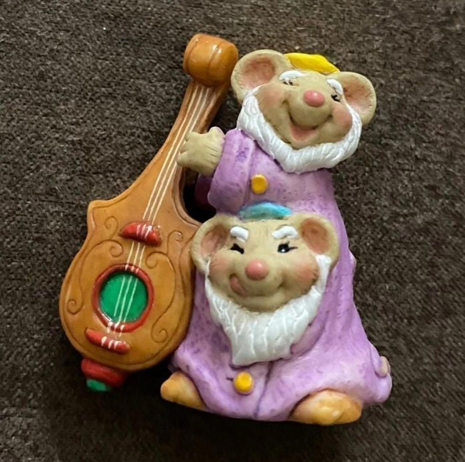 Purple-clad dwarf figurine with a brown harp accessory and a second dwarf beside it.