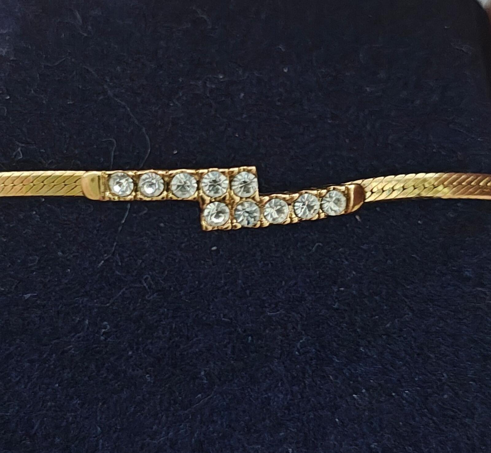 Gold tone bypass bar centerpiece with crystal rhinestone grid, close-up