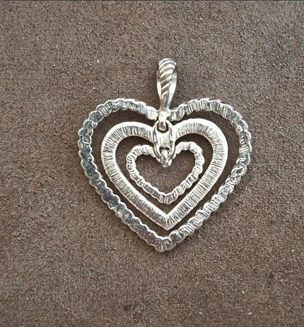 Silver heart pendant with rope border and raised rhinestone heart center, angled