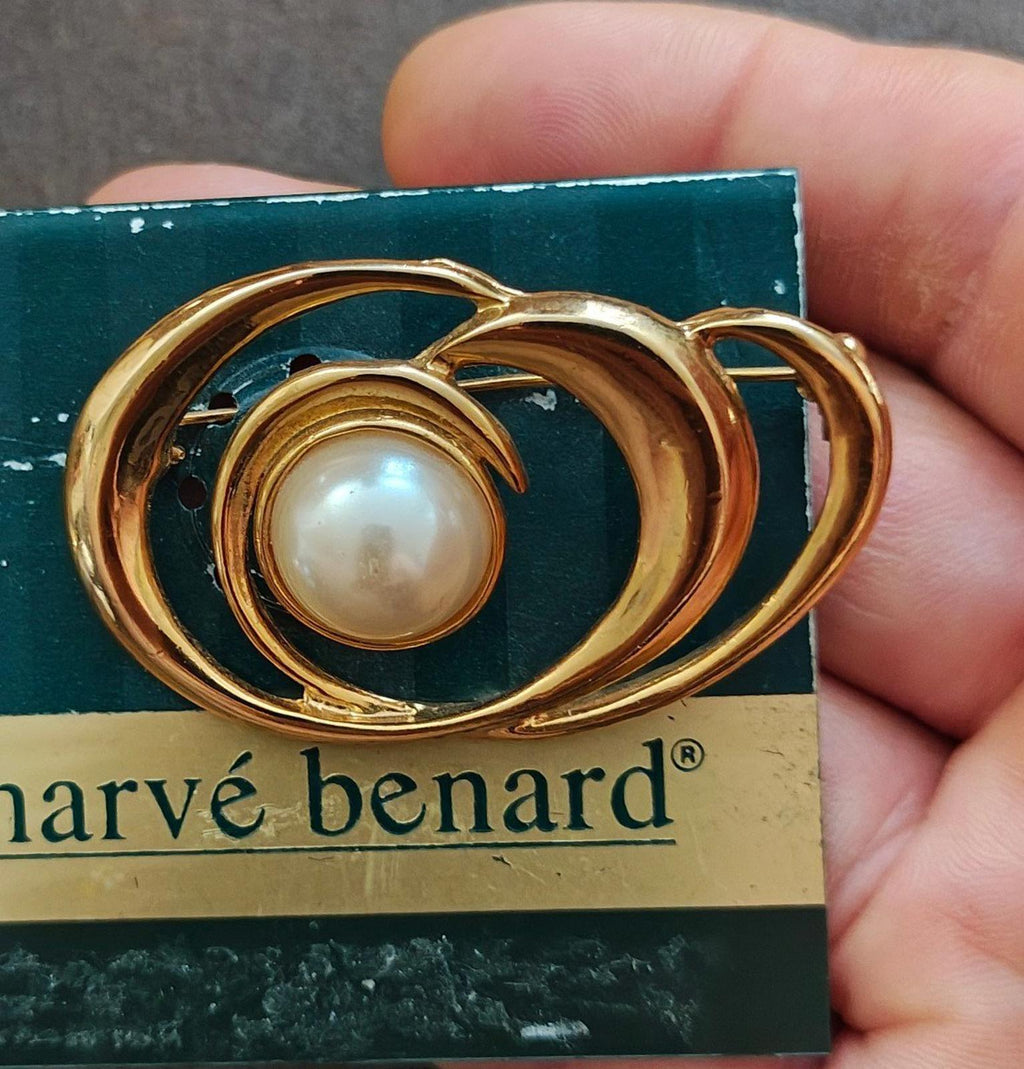 Handheld gold-tone swirl brooch with faux pearl cabochon