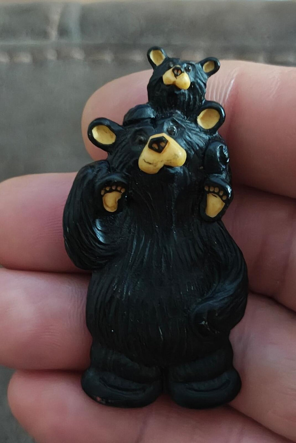 Black bear and baby bear plastic pin, front view with yellow face accents and claws