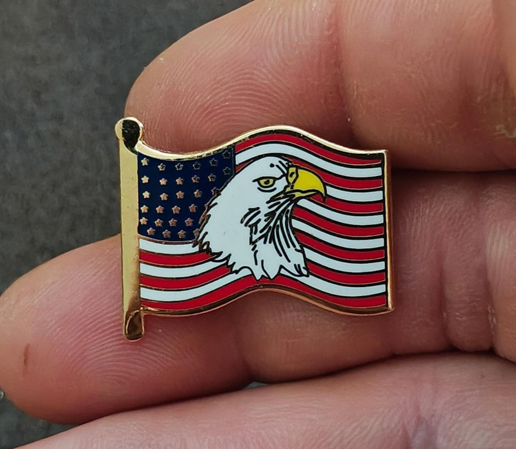 Gold-tone enamel wavy American flag lapel pin with bald eagle and red white stripes