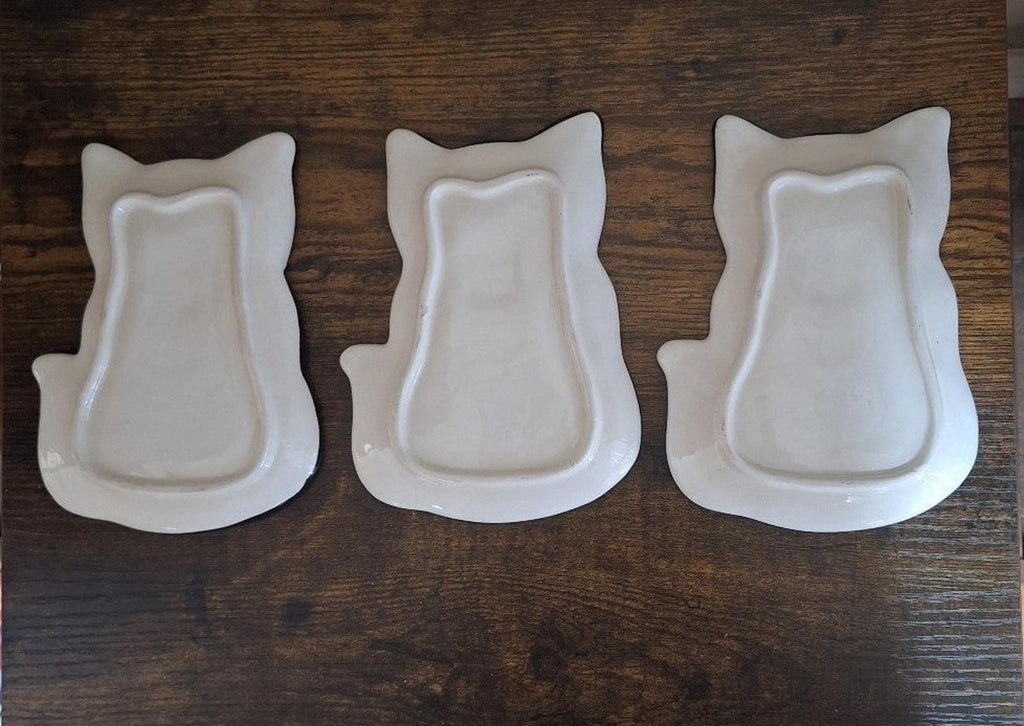 Set of three white 3D cat-shaped trinket plates with smooth back profiles