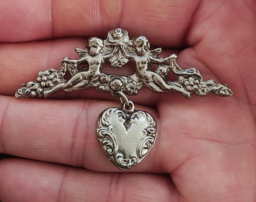 1980s Silver Tone Renaissance Style Cherub Brooch With Dangling Heart Charm
