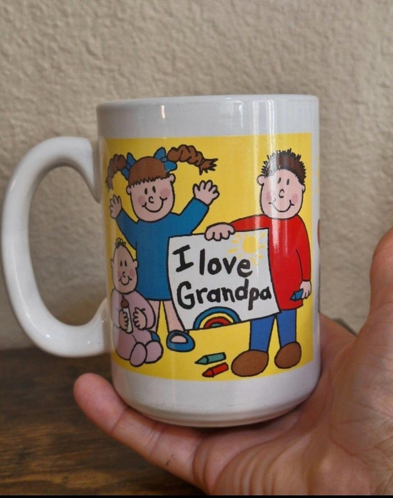 White ceramic mug with “I love Grandpa” text and cartoon characters, yellow background