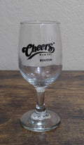 Cheers Boston stemmed wine glass with black logo print on clear glass