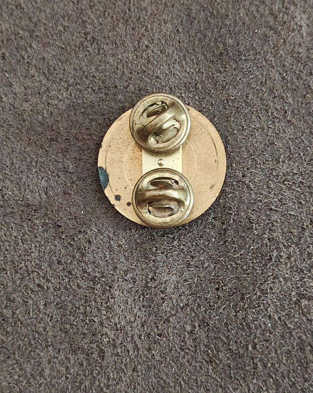 Gold circular brass pin back with safety clasp and hinge