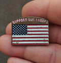 Gold-tone enamel pin with red, white, and blue U.S. flag and “Support Our Troops” text